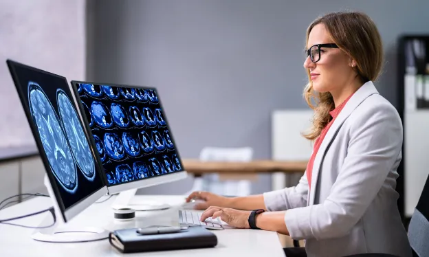 PACS Administrator at Work on Computer in Hospital System - MTMI